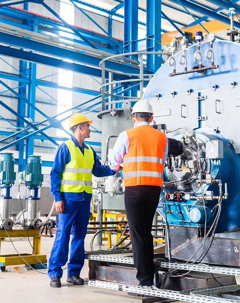 Factory worker monitoring industrial equipment as part of a preventive maintenance routine using M1 Software